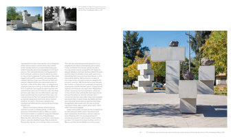 A two-page spread from a book featuring text and photographs of large, outdoor sculptures in a park. The main image on the right is a color photograph of a monumental sculpture made of stacked, light-gray geometric blocks, with large, dark rocks resting on top. The left page has two smaller installation views, one in black and white showing people playing in a sculpture that doubles as a fountain.