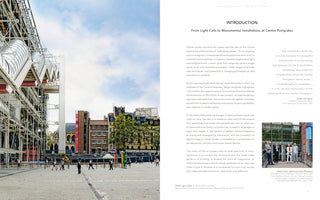 A two-page book spread about an art exhibition at the Centre Pompidou. The left page is a large photo showing the museum's iconic exterior, with its exposed pipes and scaffolding, overlooking a public square with a tall, white rectangular sculpture. The right page features text titled Introduction, with a smaller inset photo of four men at the exhibition's opening.