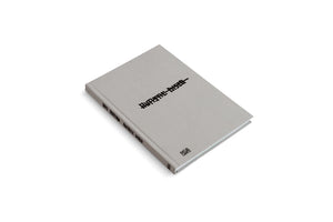 An angled, overhead view of a gray, cloth-bound hardcover book on a white background. The book's title, Autistic Disco, is written in a black, pixelated font on the cover and spine, along with the author's name, Lars Eidinger. The publisher's logo, Hatje Cantz, is on the bottom right of the cover.