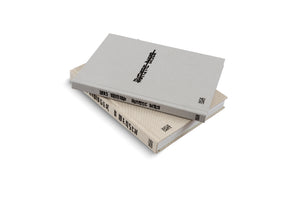 A studio shot of two hardcover books by Lars Eidinger, published by Hatje Cantz, stacked at an angle on a white surface. The top book has a light grey textured cloth cover with the title Autistic Disco on the spine in a black, stylized font. The bottom book has a beige textured cloth cover with similar black text.