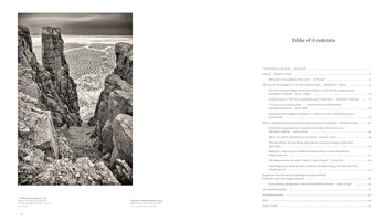 A two-page spread from a book. The left page features a dramatic black-and-white photograph of tall, jagged rock formations overlooking a vast, frozen sea with patterns of ice. The right page shows the Table of Contents, listing chapters and essays on the theme of the Arctic.