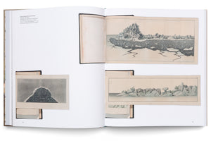 An overhead photograph of an open book. Pages 72 and 73 feature three foldout aquatint illustrations by Baron Ferdinand Petrovich Wrangel from 1827. The vintage prints depict stylized arctic landscapes with jagged icebergs and dark, icy water in shades of grey and blue, pasted onto the modern white pages of the book.