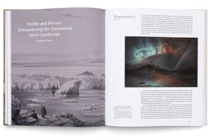 An overhead shot of an open book. The left page is titled Feeble and Heroic: Encountering the Fantastical Arctic Landscape and features a large black-and-white illustration of a ship among icebergs. The right page displays text alongside a color painting of the Aurora Borealis glowing above a dark, frozen landscape.