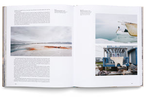 An open book showing a two-page spread with text and color photographs about life in the Arctic. The left page shows a snowy landscape with blood on the ice. The right page has two photos: a person in a boat on icy water, and a blue house with an animal hide and meat drying on the porch.