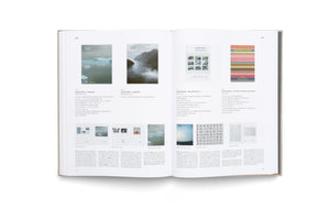An overhead shot of an open, thick, hardcover art book on a white surface. The two-page spread, pages 254 and 255, is a catalog from 2020 displaying works by the artist Gerhard Richter, featuring images of book covers and art pieces accompanied by descriptive text in German.