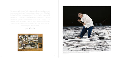 A two-page book spread. The left page features a quote by Antony Gormley and a small photo of numerous ink brushes of various sizes. The right page shows a large photo of an older Asian artist, barefoot in a white shirt and blue pants, using a very large brush to paint bold, black, abstract strokes onto a massive white canvas laid across the floor.