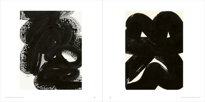 An open art book displays two abstract black-and-white paintings on facing pages. The left painting features textured, swirling black brushstrokes. The right painting consists of bold, solid black shapes with rounded tops and intersecting forms that create small, triangular negative spaces.