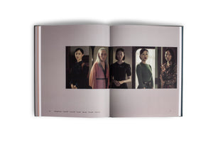 An open book shot from above on a white background. The pages display a series of five vertical portraits of different Asian women, varying in age and style. The cinematic images are identified in text as video stills from a work titled Moving Portraits.