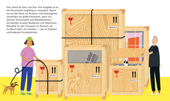 A colorful illustration shows two art handlers, a woman and a man, packing artworks into large wooden shipping crates on a yellow floor. The woman holds a packing strap while a small dog tugs on it. The man places a lid on a crate where a black and white cat is peeking out. The crates are marked with FRAGILE labels and contain various pieces of art.