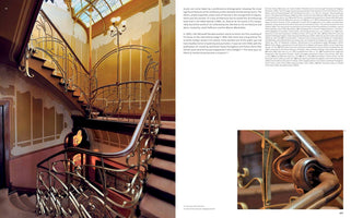 A page from a book on Art Nouveau architecture, featuring two images and text. The main image on the left shows an elegant, curving staircase with a dark wood handrail and intricate, plant-like metal balustrades. The staircase is illuminated by a lamp post integrated into the railing and a stained-glass skylight. To the right is a column of text and a smaller, close-up image showing a detailed, swirling carving on the wooden handrail.