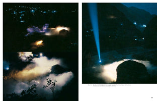 A two-page book spread with three nighttime photographs of an outdoor art installation. In a dark, mountainous landscape, thick fog is dramatically illuminated by purple and yellow lights. A separate, larger image shows a powerful blue beam of light projecting vertically into the night sky.