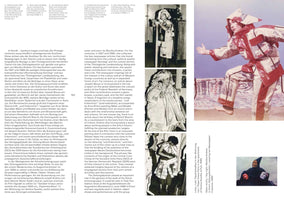 A page from a book with text in German and English, showing several photographs of people in costumes made from newspapers. The largest photo, in color, shows a person in a dynamic pose wearing a full suit and pointed hat made of newspaper with red plastic trim. To the left is a vertical series of three smaller, black-and-white photos showing other people wearing different styles of paper and newspaper clothing. The text discusses these artistic costumes created in East Germany in the late 1980s.