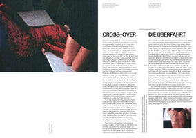 A page from a publication by Katalin Krasznahorkai. On the left is a large, grainy, close-up photograph of a person wearing a voluminous, textured red garment. On the right are two columns of text, one in English under the heading CROSS-OVER, and the other in German under the heading DIE ÜBERFAHRT. A small inset photo at the bottom right shows a close-up of two hands pulling a blue dress across a table.