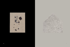 A book spread with two contrasting images. On the left page, against a black background, a beige canvas displays various small electronic components like microchips, transistors, and an SD card. On the right page, against a light grey background, is a house-shaped object made from a grey, speckled, terrazzo-like material.