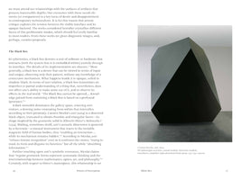 An open book showing a two-page spread. The left page contains text under the heading The Black Box. The right page features a large photograph of a monumental, black, geometric sculpture with multiple flat, angular facets. The sculpture stands in a white gallery space on a grey floor. A caption identifies the artwork as anti by Carsten Nicolai from 2004.
