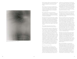 A page from an art book showing an abstract, black and white photograph on the left titled Blushes # 66. The artwork is ethereal and hazy, depicting what looks like a burst of dark particles at the top and a delicate, fan-like pattern of thin lines at the bottom on a light gray background. The right side of the spread contains two columns of text in German.
