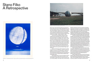 A two-page spread from an art book titled Stano Filko A Retrospective. The pages, numbered 2 and 3, contain columns of text in German and English. On the left is a blue and white artwork of a celestial globe. On the right is a color photograph of a large, white inflatable sphere installed on a grassy riverbank, with a bridge in the background.
