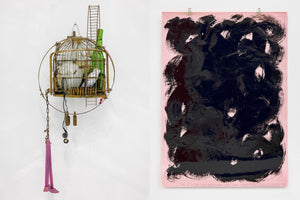 An installation view of two artworks on a white gallery wall. On the left is a sculptural assemblage made from a rusted birdcage containing a teapot and a green bottle, with a chain and a pair of pink legs hanging below. To the right is a large pink paper covered in thick, glossy black gestural brushstrokes.