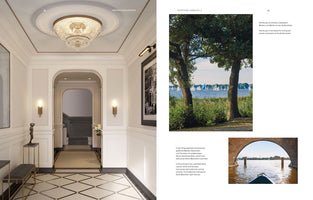 An open magazine spread from a publication titled Exceptional Homes Vol. 2. The left page shows a luxurious, white-paneled entryway with a large crystal chandelier, an arched doorway, and geometric tile floors. The right page features two scenic photos of sailboats on a lake in Hamburg, one viewed from the shore and another from under a brick arch.