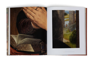 An open art book laid flat, showing a two-page spread of a classical painting. The left page is a close-up of hands clasped in prayer over an old, ornate book. The right page shows a view past the person's shoulder to a landscape with a castle and a bridge.