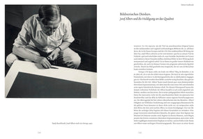 A two-page spread from a book about artist Josef Albers. On the left page is a black-and-white 1950 photograph by Rudy Burckhardt showing Albers, wearing glasses, crouched on the floor over a large canvas. He holds a paint tube and carefully uses a palette knife to apply paint to the edge of a dark square, a piece from his Homage to the Square series. The right-hand page contains German text under the title Bildnerisches Denken, Josef Albers und die Huldigung an das Quadrat.