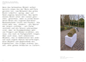 An open book spread shows a page of German text on the left and a photograph of an outdoor sculpture on the right. The sculpture consists of a rough, moss-covered concrete block with a bent metal piece on top, resting on a white plinth made of stacked rectangular panels. The artwork is situated on a cobblestone path in a garden with bare trees in the background.