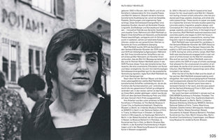A book page featuring a black-and-white photograph of the artist Ruth Wolf-Rehfeldt on the left, with her biography in German and English on the right. In the photo, Wolf-Rehfeldt has dark hair with bangs and a single braid, and she is looking off to the side. A building with the word POSTAMT is visible in the background.