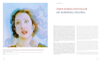An open book spread about the artist ORLAN. On the left page is her artwork, a pale, dreamlike composite portrait of a woman's face with wide eyes looking up and an open mouth. The right page shows the title, ÜBER NORM UND FIGUR / OF NORMING FIGURES, and the beginning of an essay about her work in both German and English.