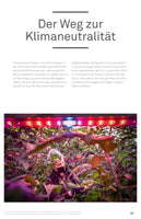 A page from a publication with the German title Der Weg zur Klimaneutralität. The main photo shows a worker in a face mask and gloves harvesting green tomatoes from lush vines inside a modern greenhouse, which is bathed in the vibrant purple glow of overhead LED grow lights.