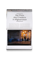 An open book page with the German headline, Der Preis des Friedens in Afghanistan. Below the text is a nighttime photograph showing a group of women in blue burqas sitting on a dark sidewalk, begging for bread in front of a brightly lit bakery in Kabul.