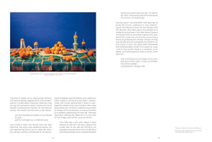 A page from an art publication with a large, colorful photograph on the left and columns of text to the right and below. The photograph is a still life of numerous tangerines, some whole and some peeled, arranged on a table covered with a blue and green patterned cloth. The table is set against a solid, deep blue background. A few small, decorative vessels are placed among the fruit.