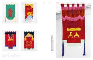 A two-page spread from an art publication displaying five elaborate, embroidered protest banners against a white background. The left page shows four smaller, colorful banners in a grid, featuring various symbols, text, and patterns. The right page is dominated by a single, large red banner decorated with an orange velvet panel, bright pink fringe, long blue tassels, and yellow embroidery of text and two seated figures.