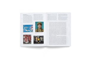 An overhead shot of a two-page spread in an open book about contemporary Chinese art, laid flat on a white surface. The left page features four color images of paintings below a column of text, while the right page is filled with two columns of text.