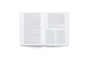 An overhead view of a book lying open on a white surface. The two visible pages are filled with neatly formatted black text, with page numbers 30 and 31 in the top corners.