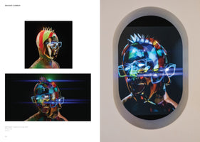 A two-page spread from an art publication for the piece INSTANT COMEDY by RAFTSIDE. On the left are two video stills of a colorful, multifaceted digital bust with a spiky crown and glowing glasses. On the right, the video is shown playing on a screen set into an oval-shaped recess in a white gallery wall.