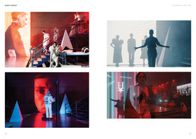A two-page spread titled Euro Hamlet, featuring four photographs of an avant-garde stage production. The images show performers in futuristic white costumes on a minimalist stage with scaffolding and large video screens projecting faces. The lighting is dramatic, with bold reds and blues, and one photo captures the performers as silhouettes against a bright white background.