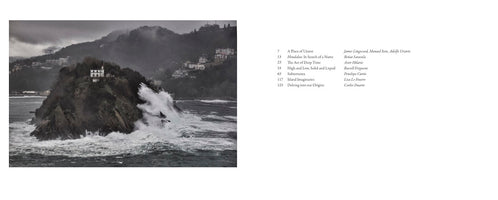 An open book spread. On the left is a dramatic, moody photograph of a large wave crashing against a rocky island topped with a single white house. On the right is the book's table of contents, listing chapter titles, page numbers, and authors.