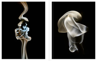 A diptych of abstract smoke photography against a solid black background. On the left, a thin, vertical wisp of golden and pale blue smoke forms a complex, intricate shape. On the right, a soft, billowing plume of white and yellowish smoke creates smooth, fabric-like folds.