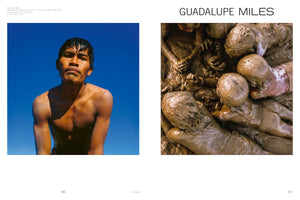 A two-page book spread featuring two color photographs by artist Guadalupe Miles. On the left, a bare-chested young man with wet hair looks up against a stark blue sky. On the right, a chaotic pile of numerous people are entangled together, their bodies completely covered in thick, brown mud.