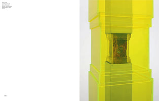 A detail of a sculpture by Paul Thek from his Technological Reliquaries series, presented on a book page. A textured, flesh-like mass in mottled shades of brown and green is enshrined within a multi-tiered, fluorescent yellow-green acrylic case. Thin, bright yellow bands are wrapped horizontally around the translucent structure against a plain white background.