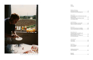 A two-page spread from a book. The left page is a full-page color photograph of the artist Jan Jedlička in the 1980s. He is standing indoors by a window, mixing paints on a white plate. On the windowsill is a row of glasses filled with colorful liquids, and the window looks out onto a rural landscape with a plowed field. The right page shows the book's table of contents in German and English.