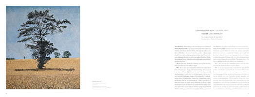 An open art book displaying a two-page spread. On the left page is a painting of a large, dark tree standing in a golden field under a light blue sky. The right page features a bilingual interview with Walter Feilchenfeldt.