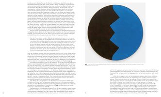 An open art book displays a two-page spread. The left page contains dense paragraphs of German text. The right page features a large, circular abstract painting with a jagged, zigzagging line dividing a deep black section on the left from a vibrant blue section on the right. Below the painting is text in English.