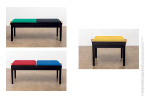 A page layout showing three minimalist benches with black wooden frames and colorful upholstered tops. On the left, a long bench with a green and black cushion is shown above another with a red and blue cushion. On the right is a smaller, single stool with a yellow cushion.