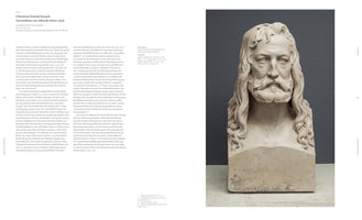 An open art catalog spread. The left page contains German text, while the right page features a large photograph of a light-colored plaster bust of Albrecht Dürer by Christian Daniel Rauch. The bust portrays a man with long, wavy hair and a full beard, gazing forward with a solemn expression against a dark gray background.