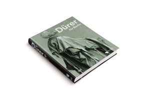 An angled, high-view shot of a black-spined hardcover book titled Dürer für Berlin. The sage green cover features a detailed ink drawing of a robed, bald figure looking upwards. The book is set against a plain white background.