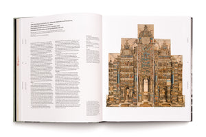 An overhead view of an open art book on a white background. The left page contains two columns of German text. The right page features a large, full-color reproduction of the Triumphal Arch of Maximilian I, a highly detailed and complex 16th-century woodcut print depicting a monumental architectural structure covered in historical scenes and figures.