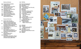 A top-down shot of a two-page spread from a publication. The left page features a table of contents in black text on a white background. The right page displays a full-page photograph of a corkboard filled with a dense collage of pinned-up historical photos, art reproductions, and small documents. The board sits atop a piece of dark, carved wood furniture.