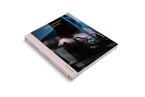 A hardcover copy of the book Image Cities by Anastasia Samoylova, angled on a white surface. The cover features a dark, moody photograph, and the book has a light pink spine with the title, author, and Kbr Photo Award printed in black and white text.