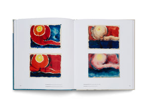 An open art book lying flat, showing a two-page spread with pages numbered 100 and 101. Each page features two abstract watercolor paintings with bold, flowing shapes in red, blue, and yellow, resembling sunsets or celestial orbs over a dark horizon. Small captions are printed below the artworks.